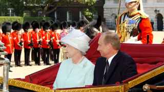 Президент России Владимир Путин (на снимке справа) и королева Елизавета II (слева) ехали в одной карете к главному входу Букингемского дворца.